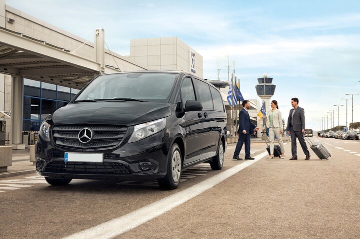 Friendly driver assisting passengers at Greece airport